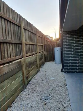 Excavator digging wall footing
